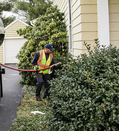 Filling a home heating oil tank during a scheduled automatic delivery in Hauppauge, NY